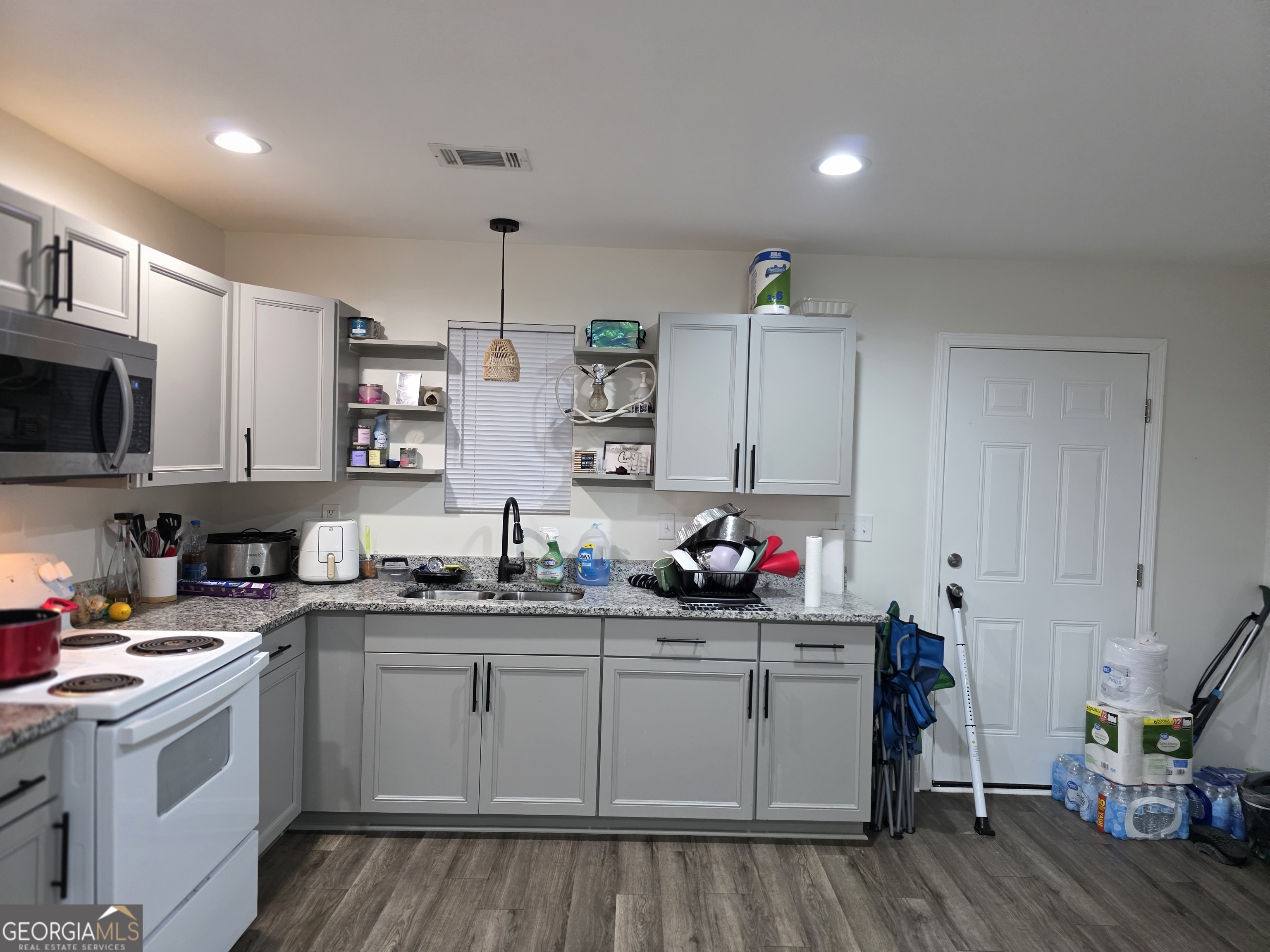 317 Preston Street Fort Valley, GA 31030 - Photo 4 of 7 a kitchen with sink cabinets and wooden floor