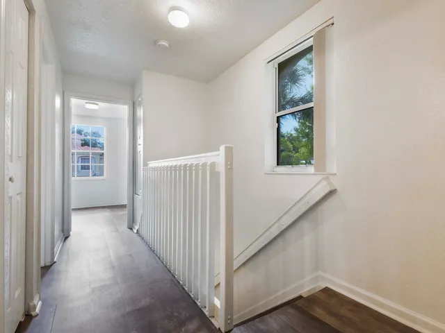 a view of a hallway with windows and entryway