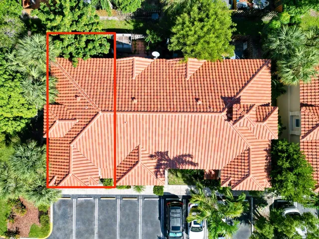 a wooden building with potted plants in front of it