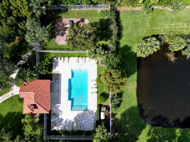 an aerial view of a house with a yard lake lake and lake view