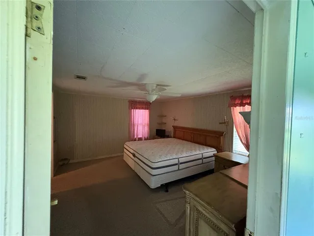 a bedroom with a bed and window