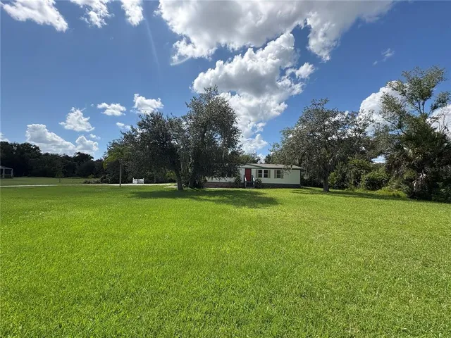 a view of a house with a big yard