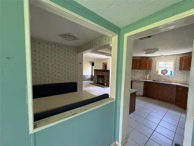 a kitchen with a sink a counter top space and appliances