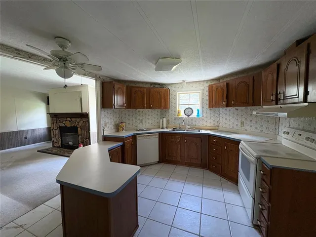 a kitchen with a sink cabinets and appliances