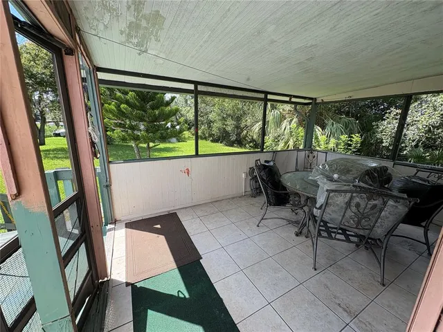 a view of a deck with wooden floor and fence