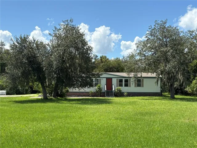 a view of house with yard and green space