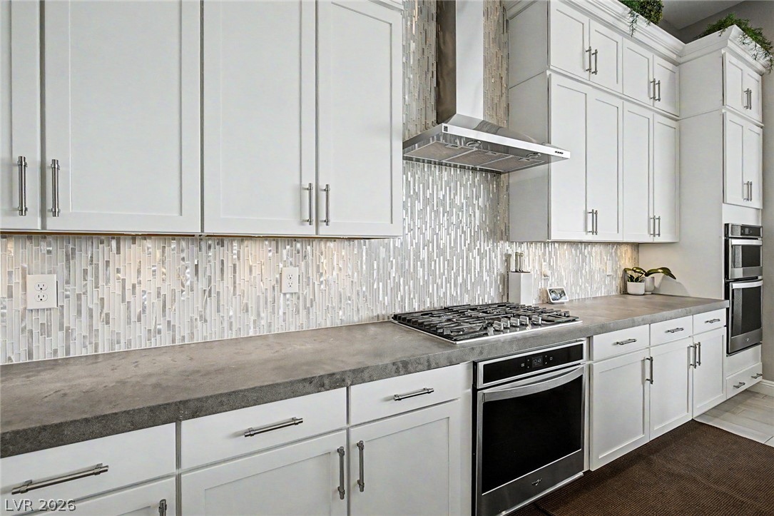 6014 Willow Ridge Court Las Vegas, NV 89135 - Photo 35 of 99 This modern kitchen features crisp white cabinetry and sleek countertops.