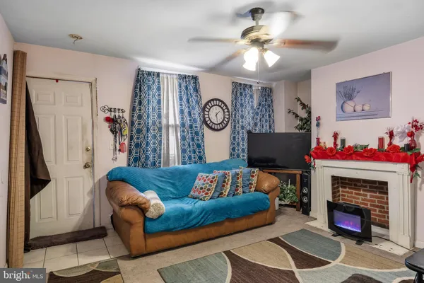 a living room with furniture and a fireplace