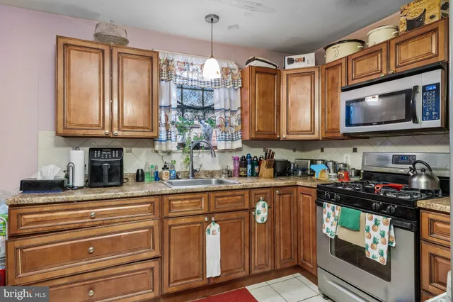 a kitchen with stainless steel appliances granite countertop a stove and cabinets