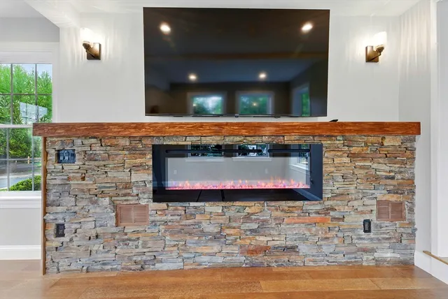 a fireplace with a screen on the wall