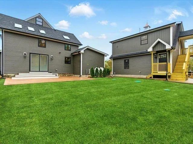 a front view of house with yard and green space