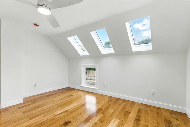 a view of empty room with wooden floor