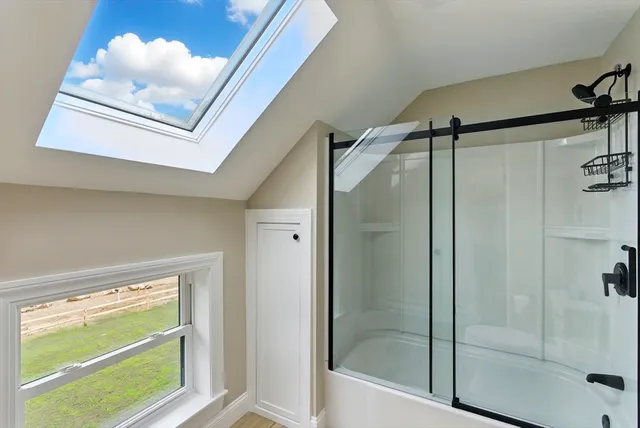 a bathroom with a shower and a view of bathtub