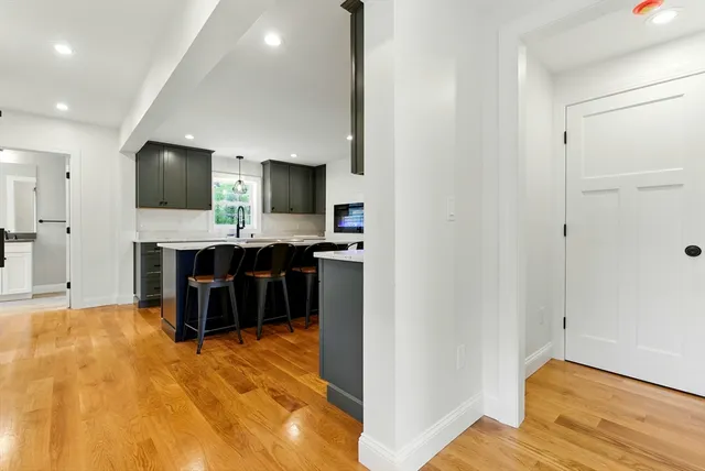a kitchen with kitchen island a sink stainless steel appliances and cabinets