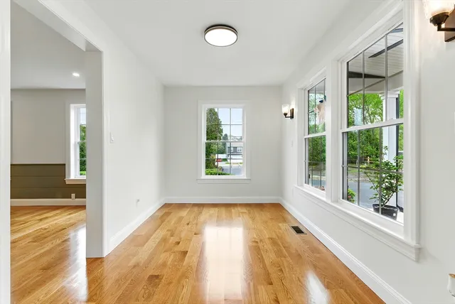 a view of a room with wooden floor and a window