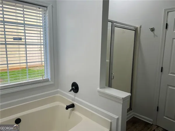 a bathroom with a bathtub and a window