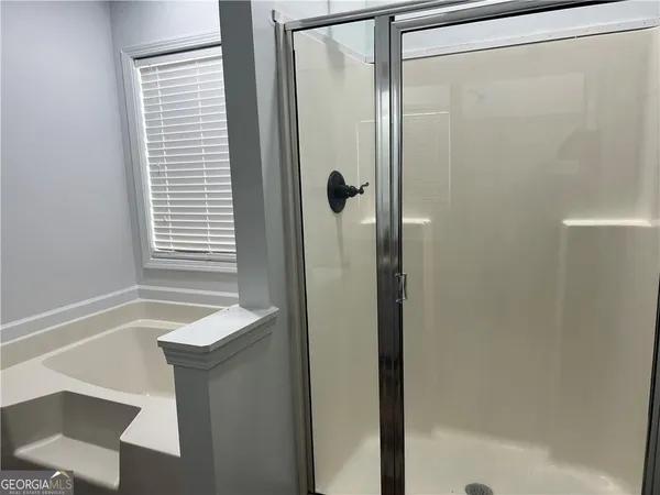 a bathroom with a shower and a sink