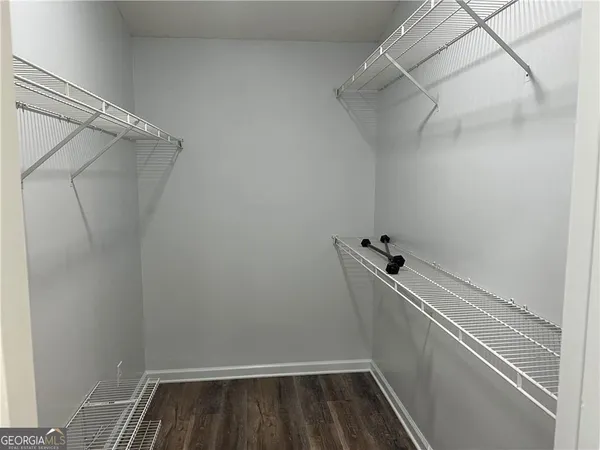 a view of walk in closet with clothes