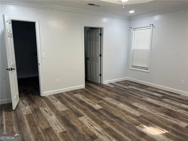 a view of a room with wooden floor and closet