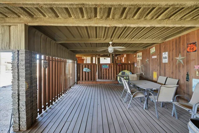 a view of a porch with wooden floor