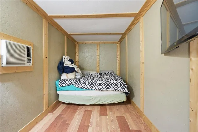 a bedroom with a bed and a dresser