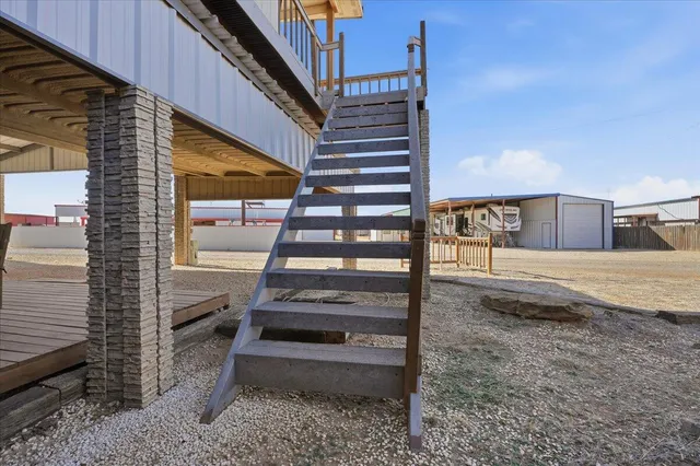 a bedroom with a bed a couch and a flat screen tv