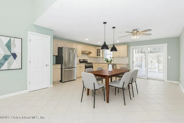 a view of a dining room with furniture and a chandelier
