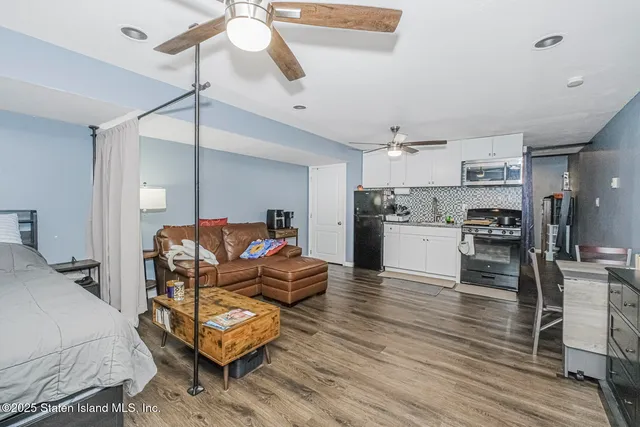 a living room with furniture and kitchen view