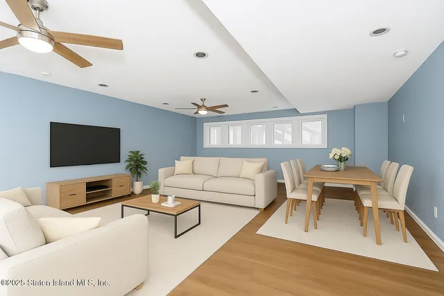 a living room with furniture a rug and a flat screen tv