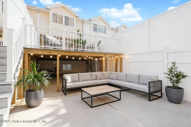 a view of a swimming pool with couches and lounge chairs