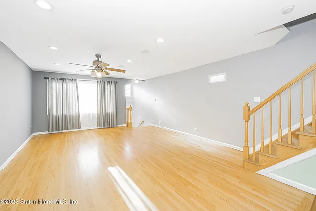 a view of an empty room and wooden floor