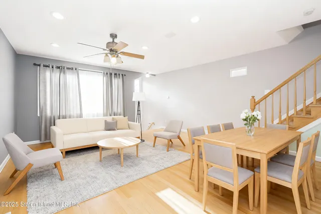 a living room with furniture a fireplace and a chandelier