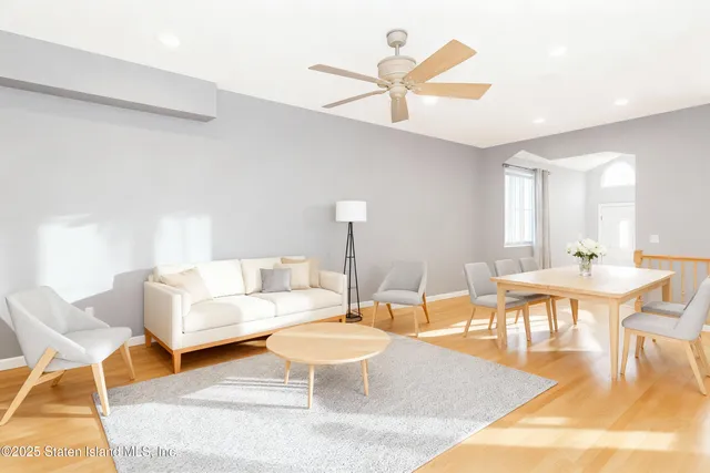 a living room with furniture a rug and a chandelier