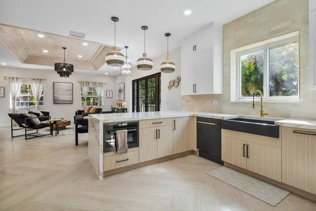 a large white kitchen with a large window