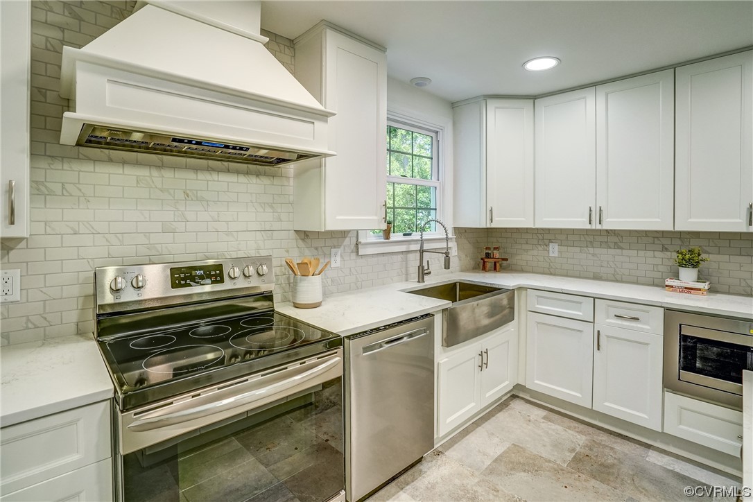 13611 Thorngate Road Midlothian, VA 23113 - Photo 14 of 49 a kitchen with a stove and white cabinets