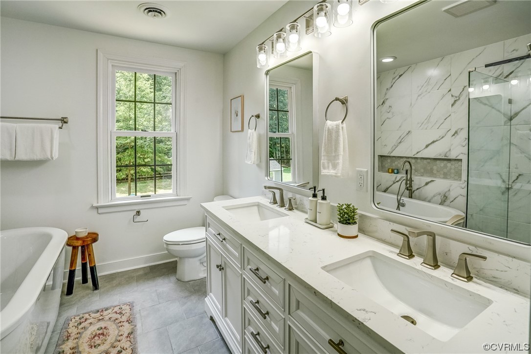 13611 Thorngate Road Midlothian, VA 23113 - Photo 29 of 49 a bathroom with a double vanity sink mirror and toilet