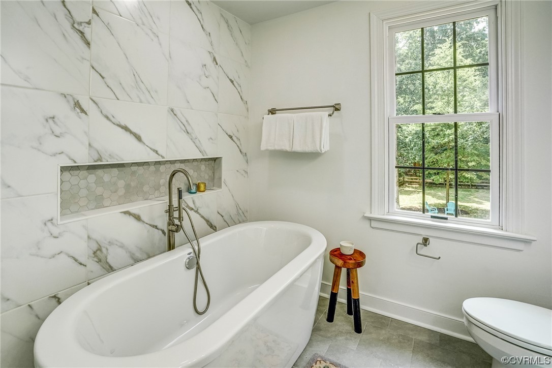 13611 Thorngate Road Midlothian, VA 23113 - Photo 30 of 49 a bathroom with a sink and bathtub with window