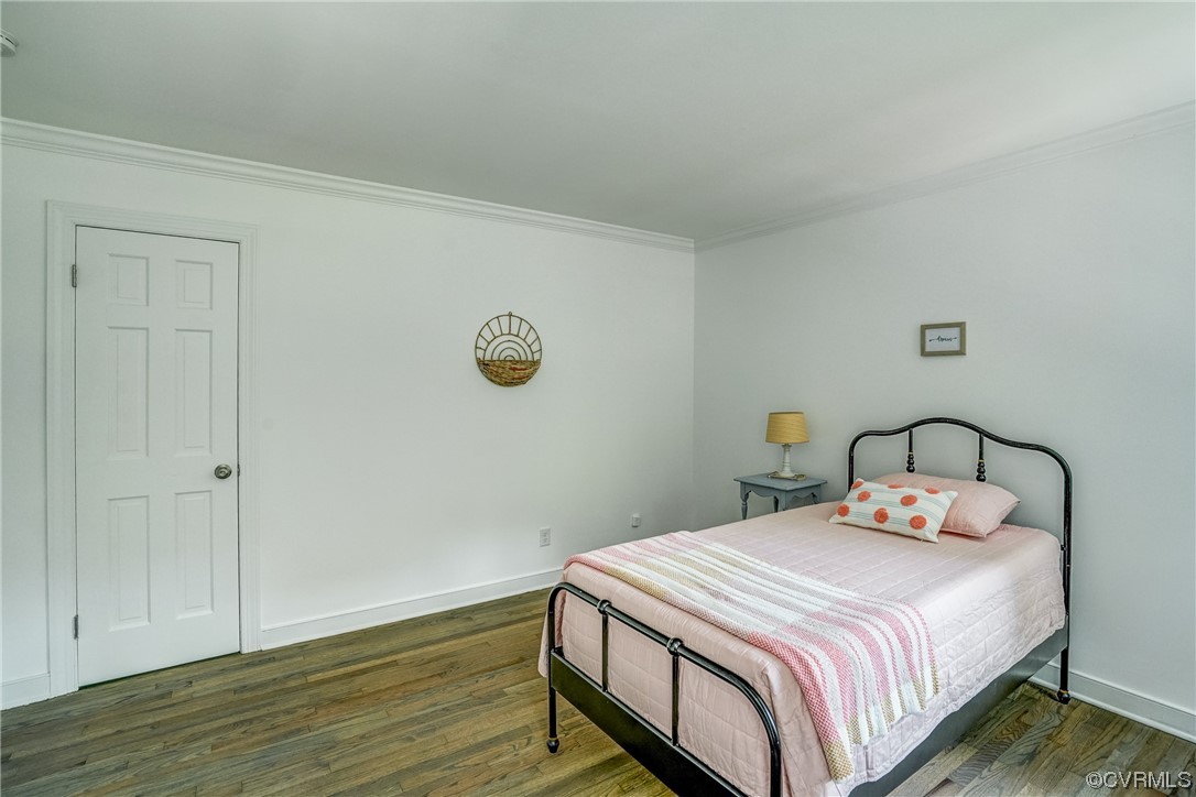 13611 Thorngate Road Midlothian, VA 23113 - Photo 34 of 49 a bedroom with a bed and wooden floor