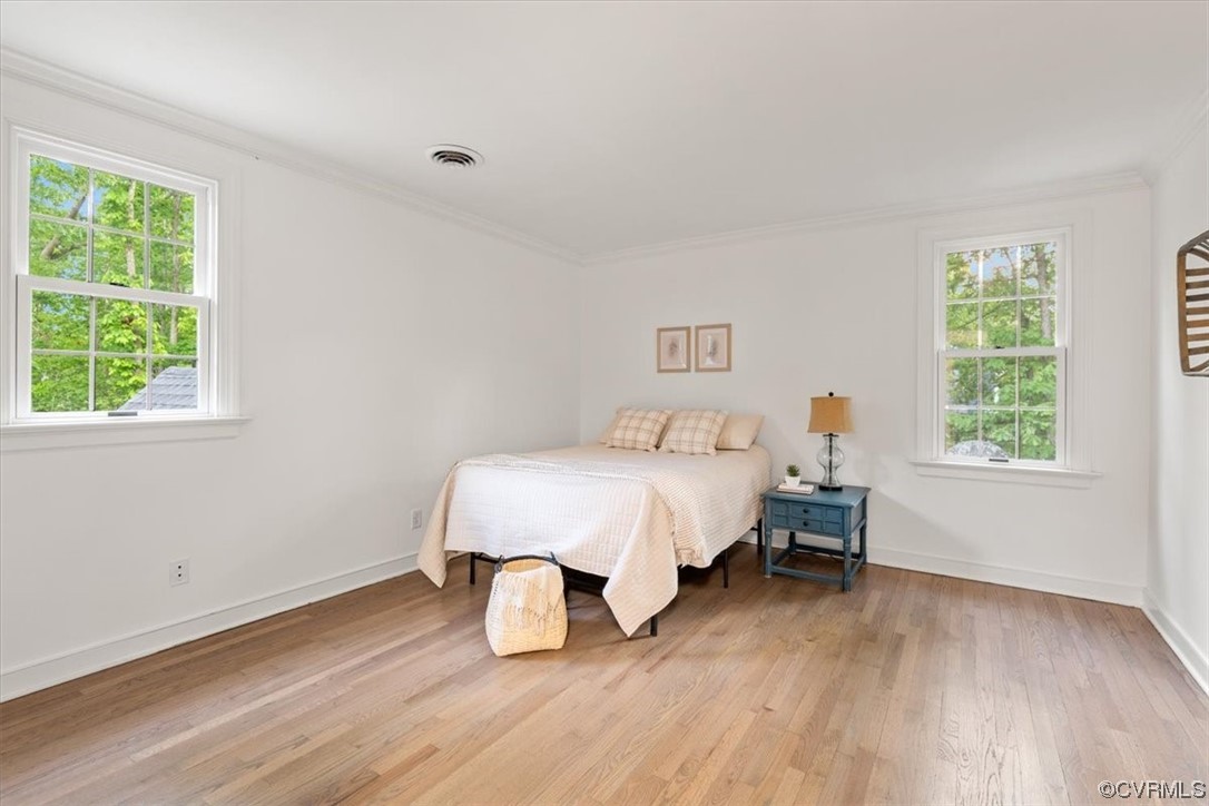 13611 Thorngate Road Midlothian, VA 23113 - Photo 35 of 49 a spacious bedroom with a bed and a wooden floor