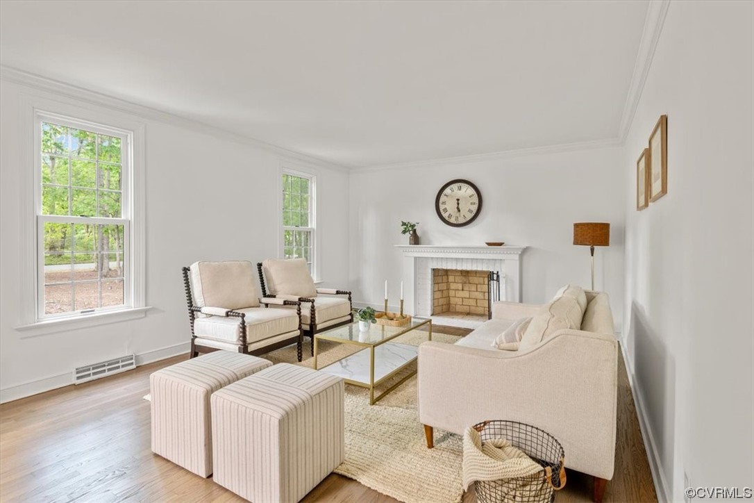 13611 Thorngate Road Midlothian, VA 23113 - Photo 4 of 49 a living room with furniture a fireplace with wooden floor