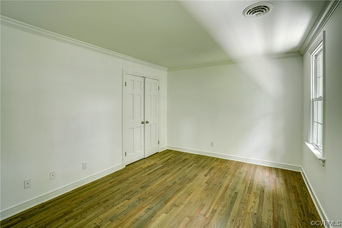 13611 Thorngate Road Midlothian, VA 23113 - Photo 41 of 49 an empty room with wooden floor and windows