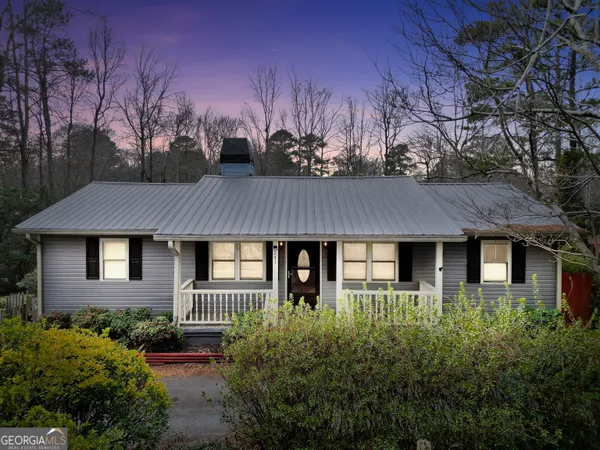 a front view of house with a garden
