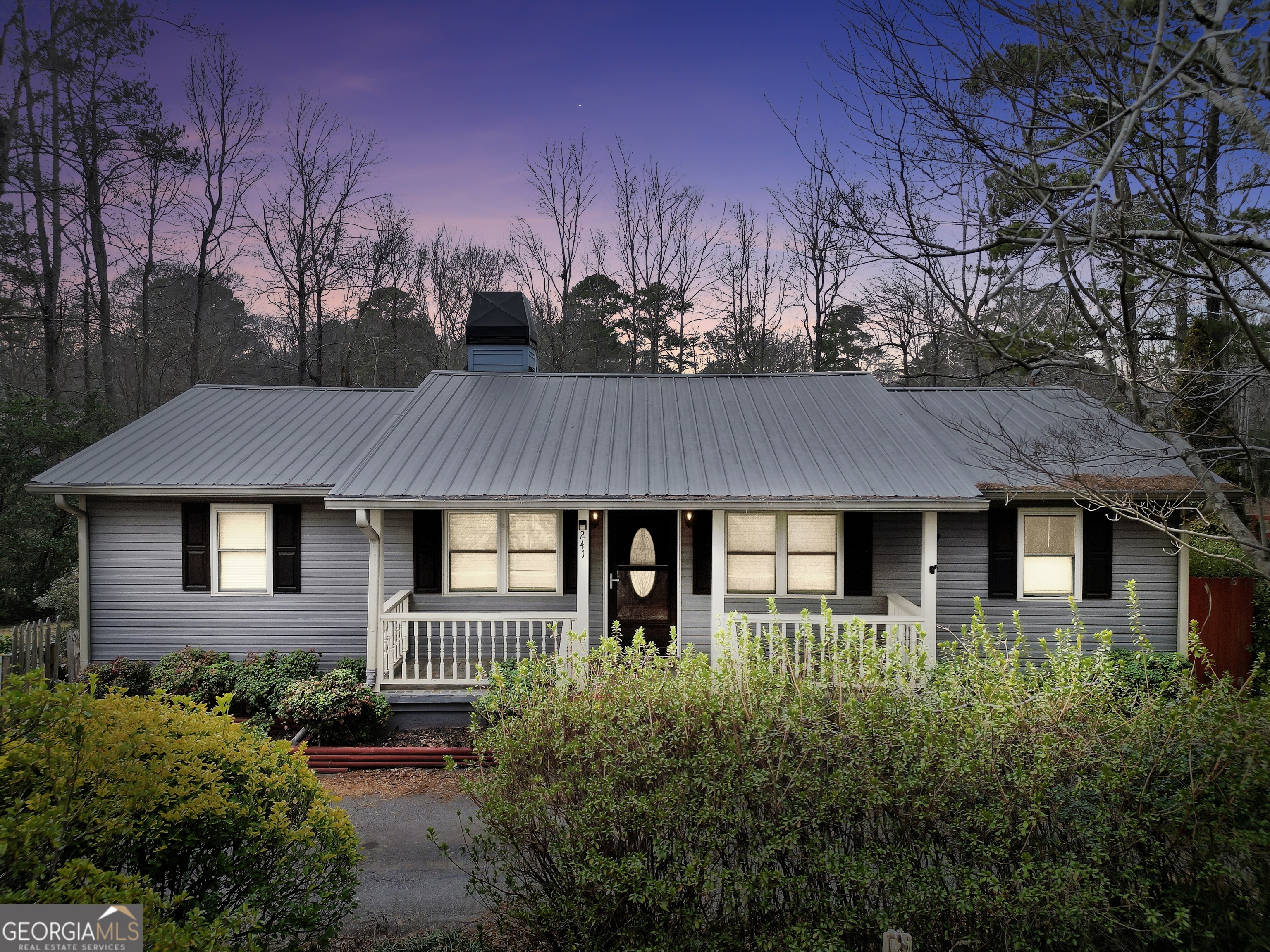 a front view of house with a garden
