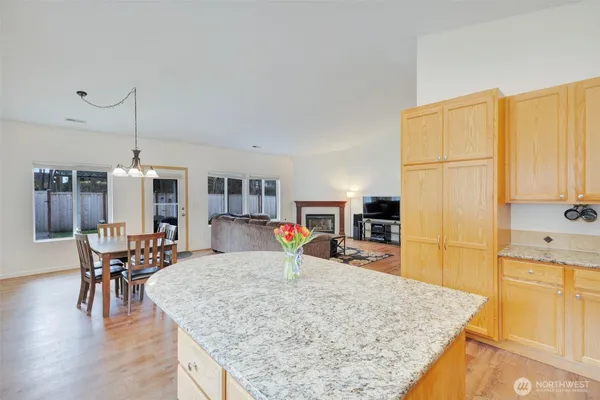 a kitchen with stainless steel appliances granite countertop sink and wooden cabinets