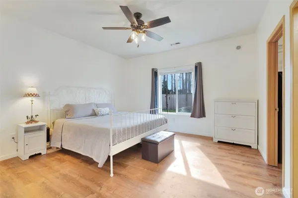a bedroom with a bed and a chandelier