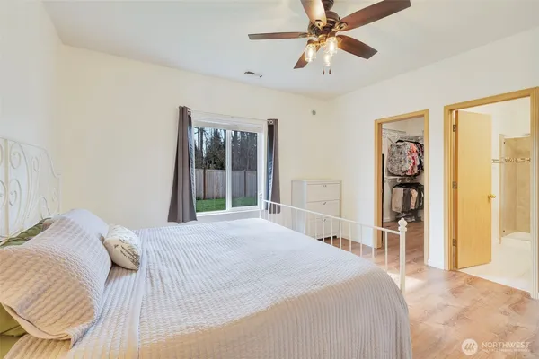 a bedroom with a bed and a large mirror