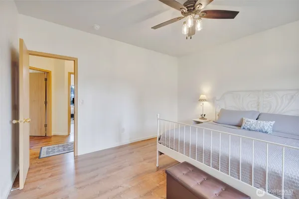 a bedroom with furniture and a chandelier fan