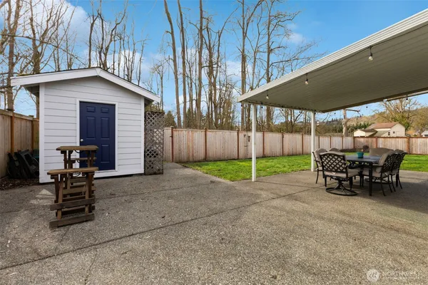 a view of a house with backyard porch and sitting area