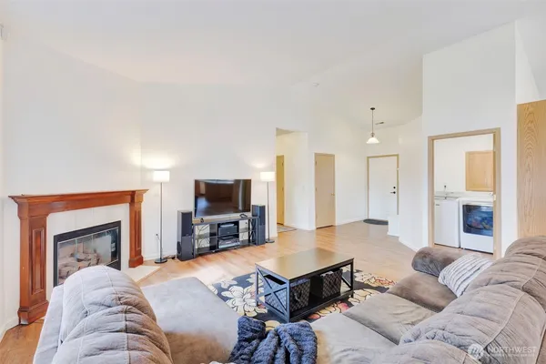 a living room with furniture a fireplace and a flat screen tv