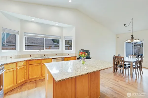 a kitchen with a sink and chairs